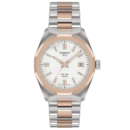 The Tissot PRC 100 Solar Quartz 34mm Watch features a white dial with gold hour markers, a date window at 3 o’clock, and a solar-powered quartz movement. It has a silver and rose gold metal band with rose gold bezel and center links.