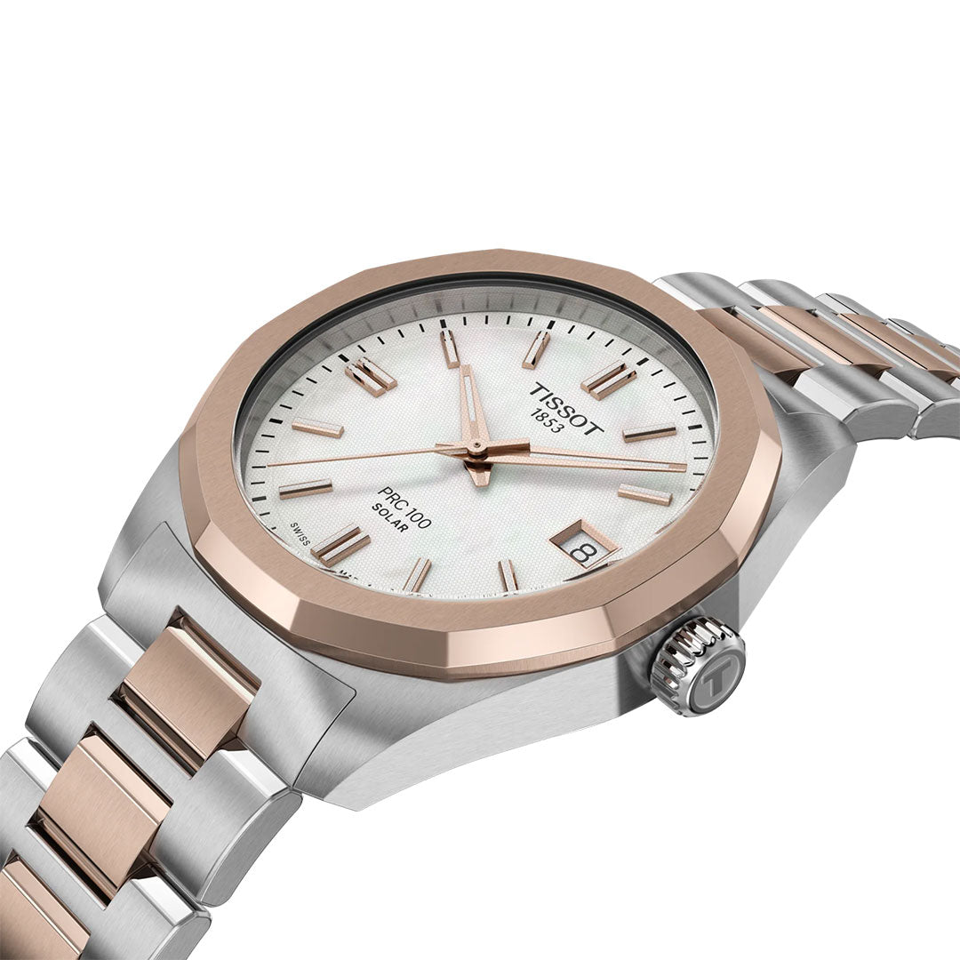 The Tissot PRC 100 Solar Quartz 34mm Watch features a silver and rose gold two-tone bracelet, white textured dial, rose gold markers and hands, date window at 3 o’clock, and is shown angled to display its face and side.
