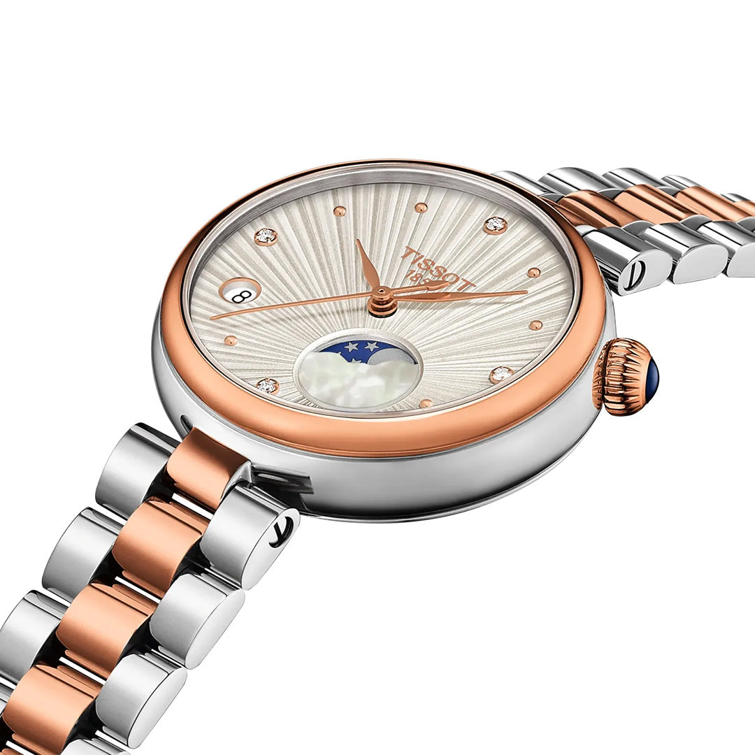 The Tissot Desir Moonphase Quartz 29.6mm Watch by Tissot features a silver and rose gold design with a textured dial, diamond hour markers, date window, and moonphase display, complemented by an elegant matching stainless-steel bracelet.