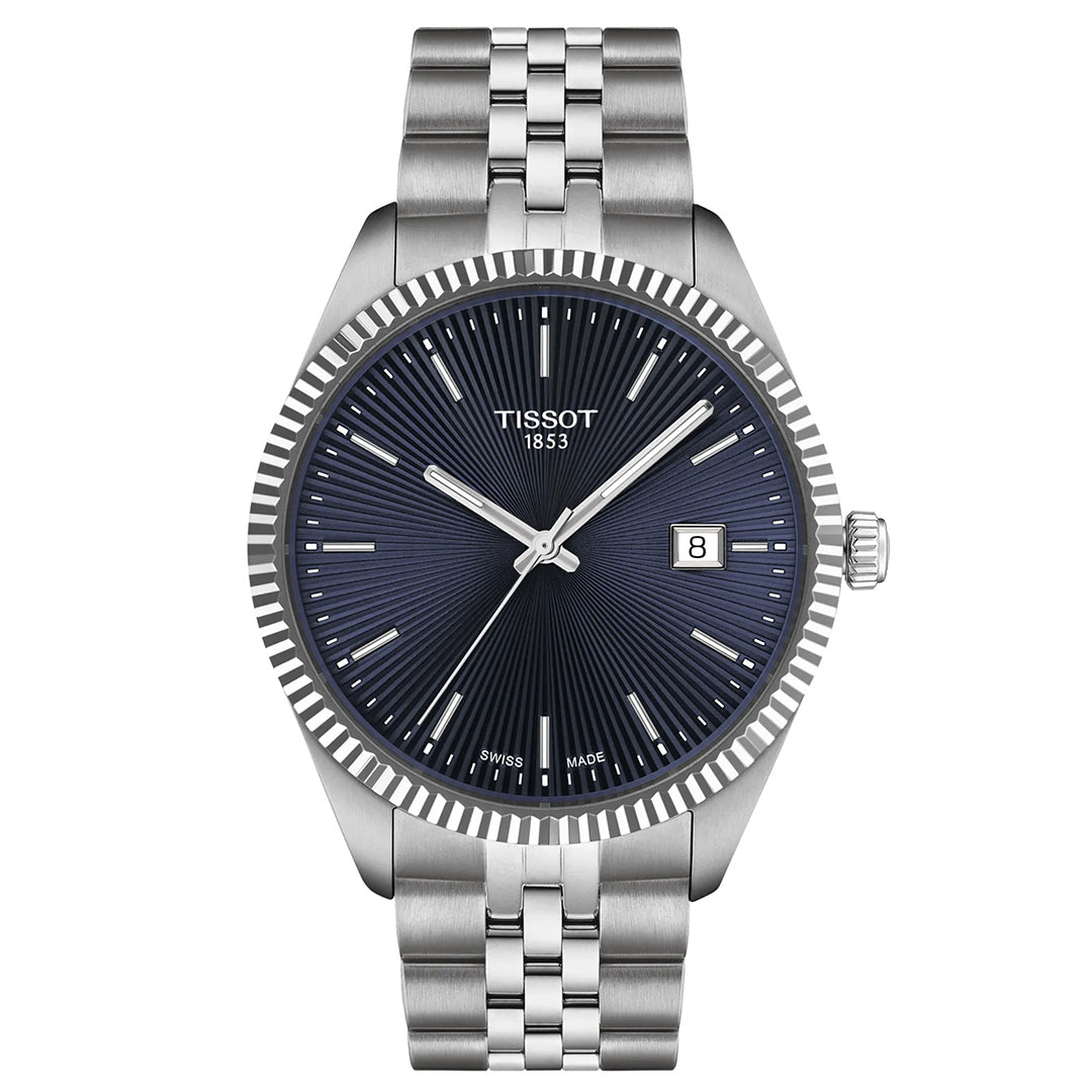 The Tissot Ballade Quartz 40mm Watch features a silver metal bracelet, fluted bezel, and dark textured dial with date display at 3 o’clock. It has silver hour markers and hands, with "Tissot" and "1853" on the face.