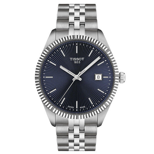 The Tissot Ballade Quartz 40mm Watch features a silver metal bracelet, fluted bezel, and dark textured dial with date display at 3 o’clock. It has silver hour markers and hands, with "Tissot" and "1853" on the face.