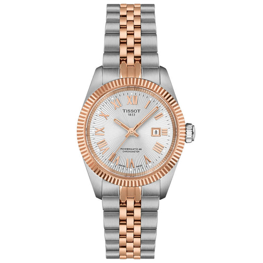 The Tissot Ballade Powermatic 80 Automatic 30mm Watch features a silver and rose gold metal band, fluted rose gold bezel, silver dial with Roman numerals, date window, three hands, and a COSC-certified Powermatic 80 movement.