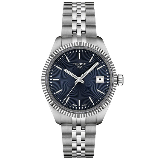 The Tissot Ballade Quartz 34mm Watch features a stainless steel case, blue guilloché dial with silver hour markers and hands, date display at 3 o’clock, and a silver metal link bracelet.