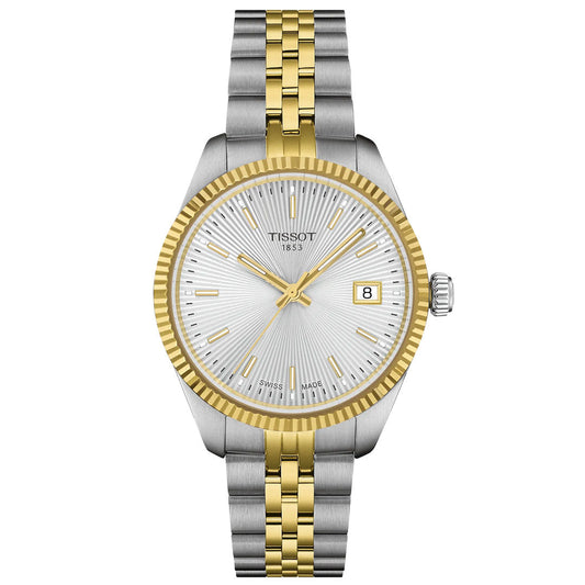 The Tissot Ballade Quartz 34mm Watch features a silver and gold metal band, silver guilloché dial, gold hour markers and hands, fluted gold bezel, and a date window at 3 o’clock.