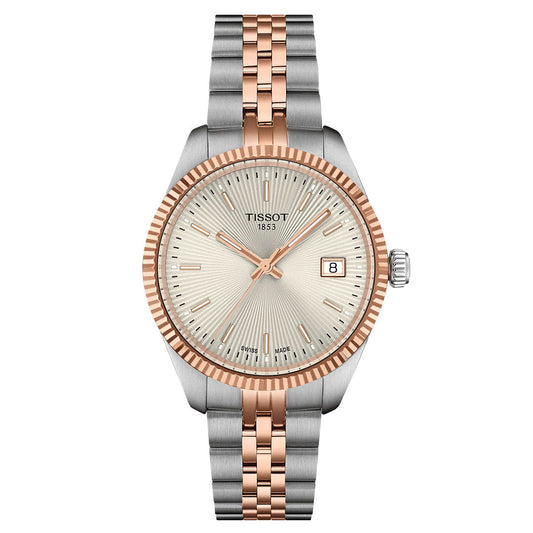 The Tissot Ballade Quartz 34mm Watch features a silver and rose gold two-tone metal band, a round guilloché dial with a rose gold bezel and hour markers, and displays the date at 3 o’clock.