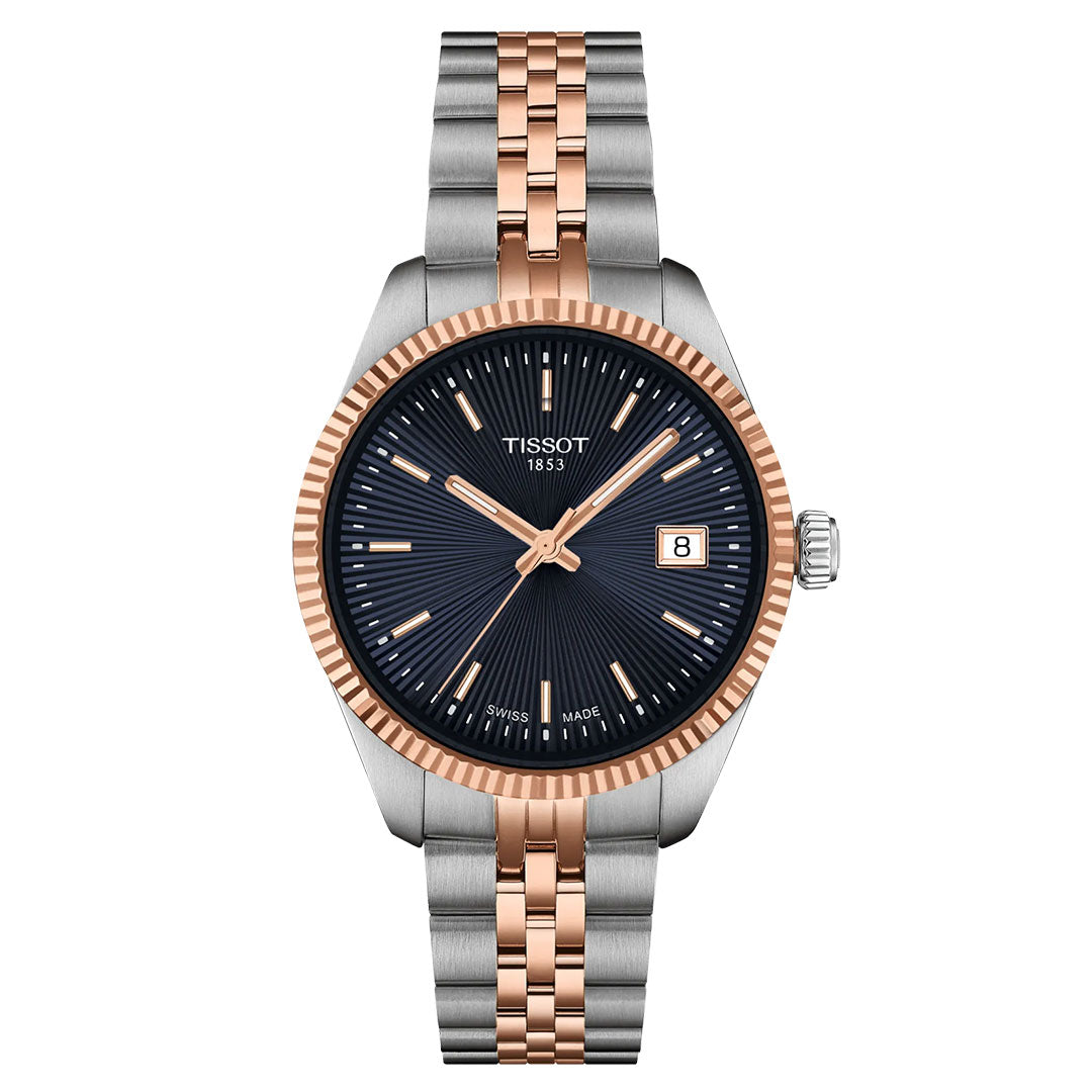The Tissot Ballade Quartz 34mm Watch features a two-tone silver and rose gold band, black guilloché dial with rose gold hands and markers, Swiss Quartz movement, date window at 3 o’clock, and a fluted rose gold bezel.