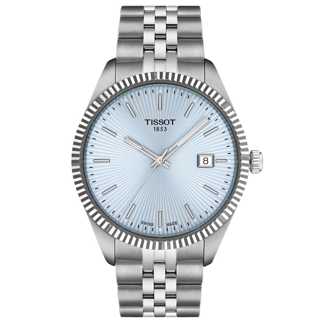 The Tissot Ballade Quartz 40mm Watch features a silver case and bracelet, light blue guilloché dial, silver hour markers and hands, date display at 3 o'clock, and a minimalist, elegant design.