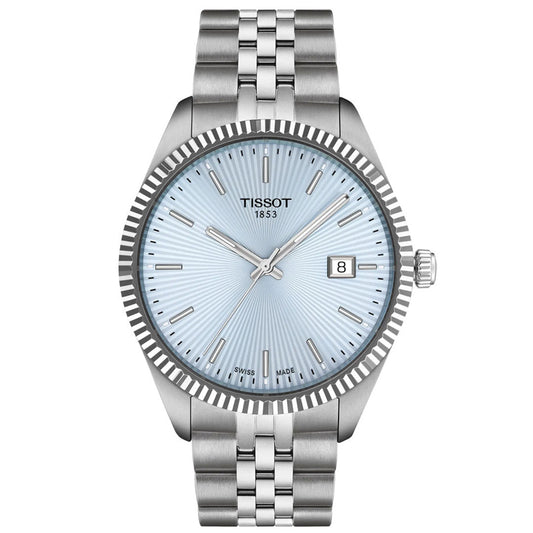 The Tissot Ballade Quartz 40mm Watch features a silver case and bracelet, light blue guilloché dial, silver hour markers and hands, date display at 3 o'clock, and a minimalist, elegant design.