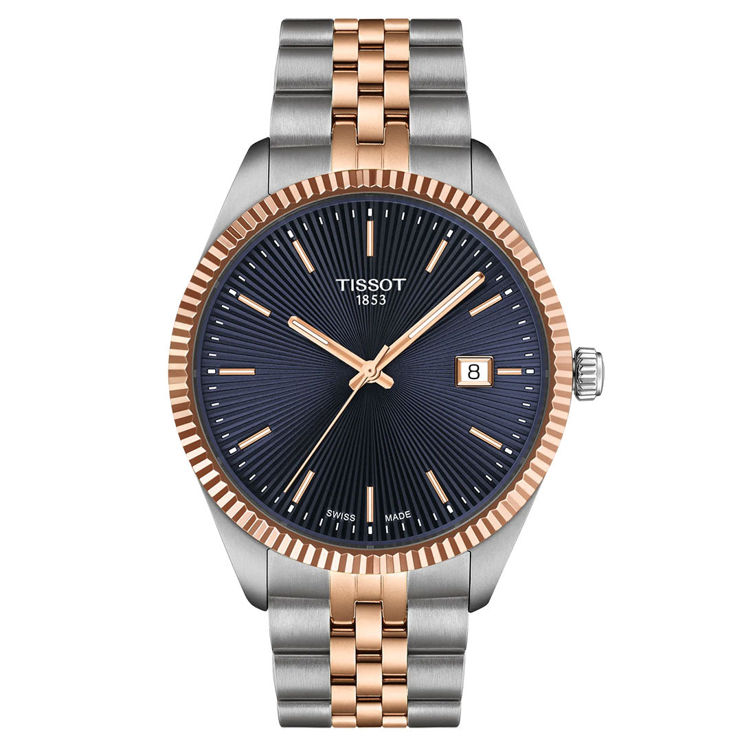 The Tissot Ballade Quartz 40mm Watch by Tissot features a navy blue guilloché dial, rose gold-tone hands and markers, Swiss Quartz movement, date window at 3 o’clock, and a two-tone silver and rose gold PVD bracelet.