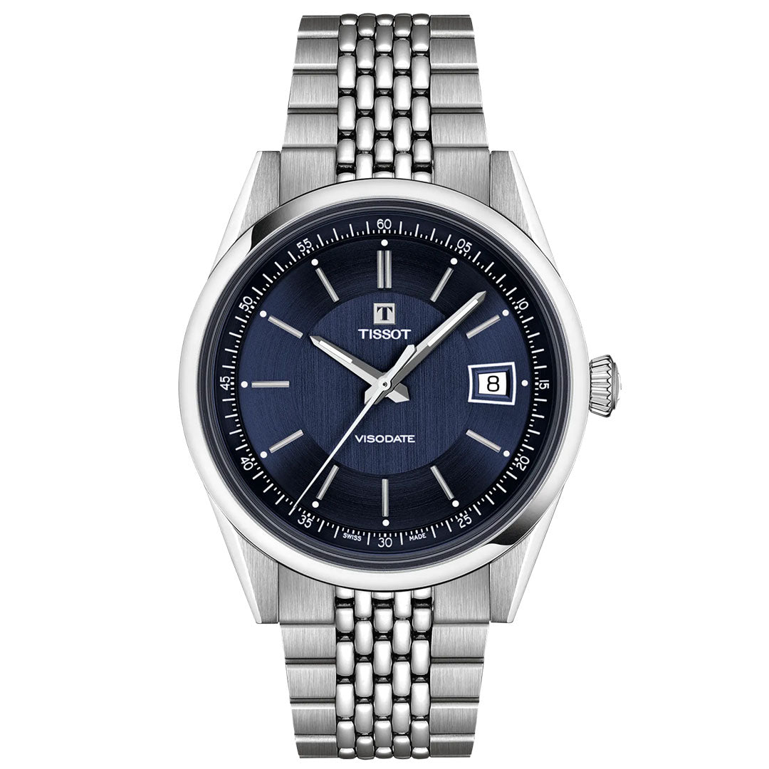The Tissot Visodate Automatic 39mm Watch features a blue dial, silver hour markers, date at 3 o’clock, and a stainless-steel bracelet for a refined look.