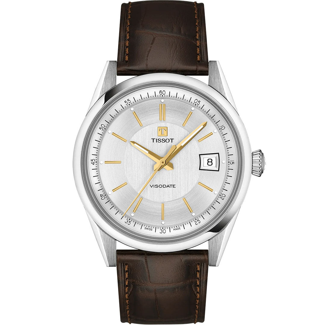 The Tissot Visodate Automatic 39mm Watch features a silver dial with gold hour markers and hands, Powermatic 80 movement, date at 3 o’clock, stainless steel case, and a brown leather strap with visible stitching.
