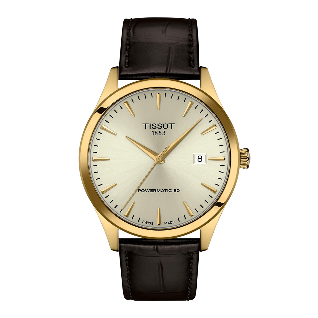 The Tissot Classic Dream Swissmatic 40mm Watch features a gold case, white dial with simple hour markers, black leather strap, scratch-resistant sapphire crystal, date at 3 o’clock, and displays “Tissot 1853” and “Powermatic 80” on the face.