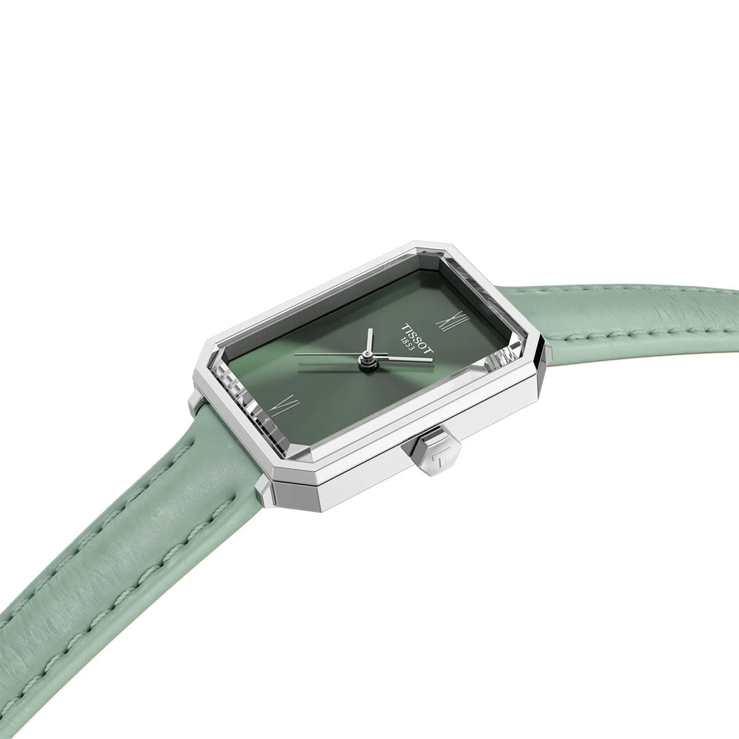 The Tissot SRV Quartz 30mm Watch features a rectangular silver case, green face with minimalist hour markers, and a light green leather strap, shown at an angle on a white background.