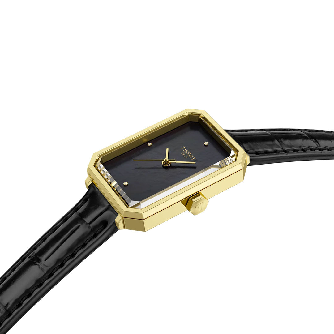 The Tissot SRV Quartz 30mm Watch features a gold case, black dial, minimalist gold hands, and a black textured leather strap, shown at an angle on a white background.