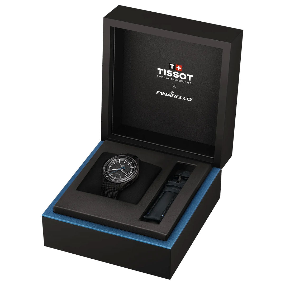 The Tissot Pinarello Mechanical Automatic COSC 43mm Watch features a forged carbon case, matching band, extra strap, and comes in an open black presentation box with "Tissot x Pinarello" branding on the inside lid.