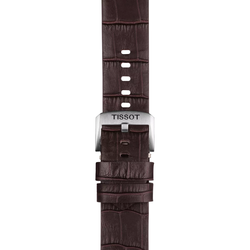 A detailed view of the Tissot Official Brown Leather Strap with 22 mm lugs, featuring a silver buckle engraved with the Tissot logo and textured brown leather reminiscent of a crocodile pattern.