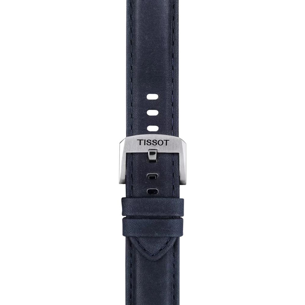 A close-up of the Tissot Official Blue Leather Strap Lugs 20 mm, featuring navy blue leather with multiple adjustment holes, visible edge stitching, and a silver buckle engraved with "TISSOT.
