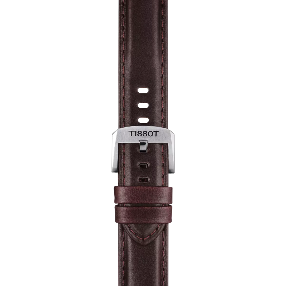 The Tissot Official Brown Leather Strap (Lugs 20 mm) by Tissot is displayed vertically against a white background. This strap features brown leather with multiple adjustment holes, two loops for securing the end, and a silver buckle engraved with "TISSOT.
