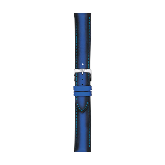 The Tissot Official Blue Leather Strap, featuring light blue stitching and a silver buckle, is displayed vertically on a white background. This 20 mm strap is branded "Tissot.