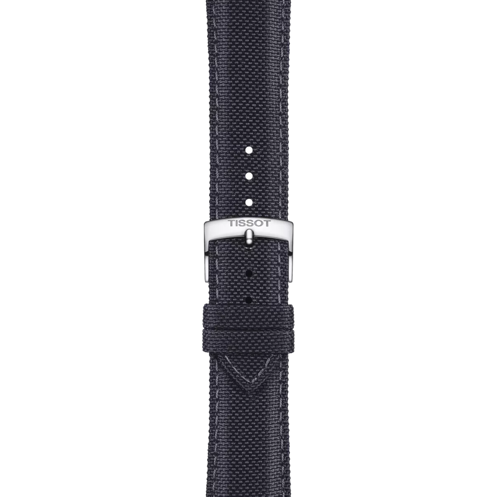 A close-up of the Tissot Official Anthracite Fabric Strap Lugs 21 mm showcases the black fabric material and a silver buckle engraved with "TISSOT" against a white background. Four size adjustment holes are visible.