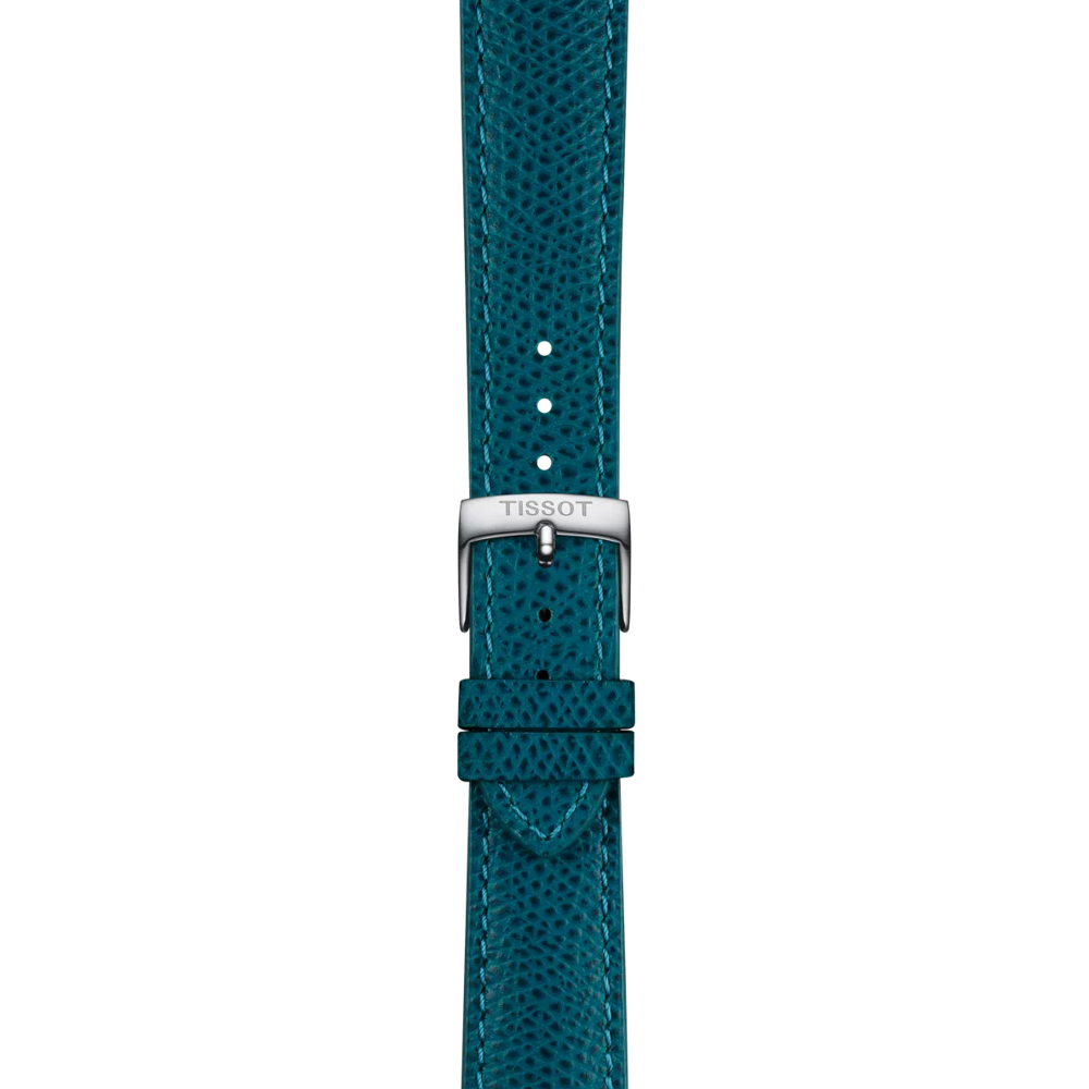 The Tissot Official Turquoise Leather Strap features a textured leather design with visible stitching, multiple adjustment holes, and a silver buckle engraved with "TISSOT." Displayed vertically against a white background, this strap is designed for 18 mm lugs.