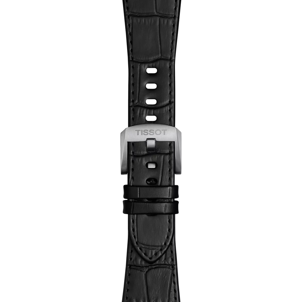 Close-up of the Tissot Official Black PRX 42mm leather strap, featuring a black leather band with visible stitching and multiple adjustment holes. The silver buckle is engraved with the "TISSOT" brand name, all displayed against a plain white background.