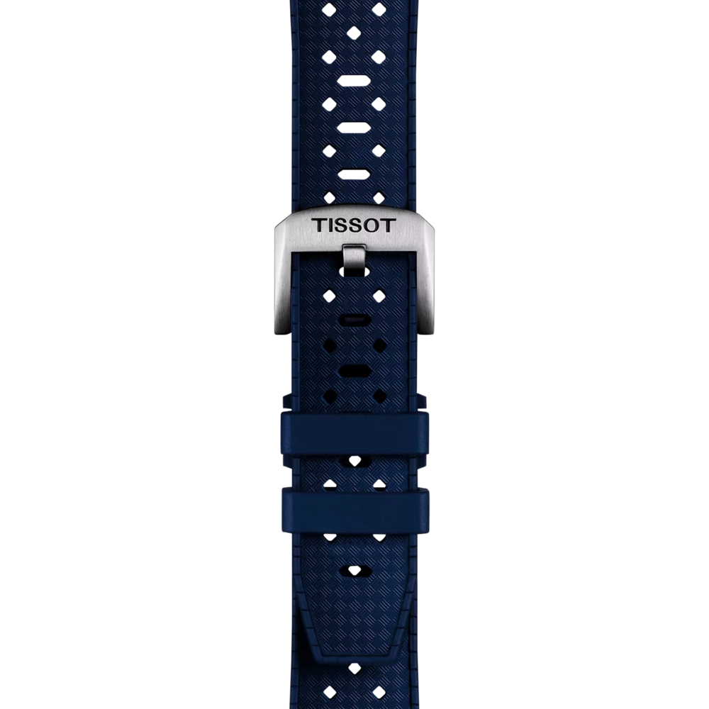 The Tissot Official Blue Rubber Strap Lugs 20mm features a blue patterned design and a metal buckle engraved with the “Tissot” brand name, displayed vertically on a white background.