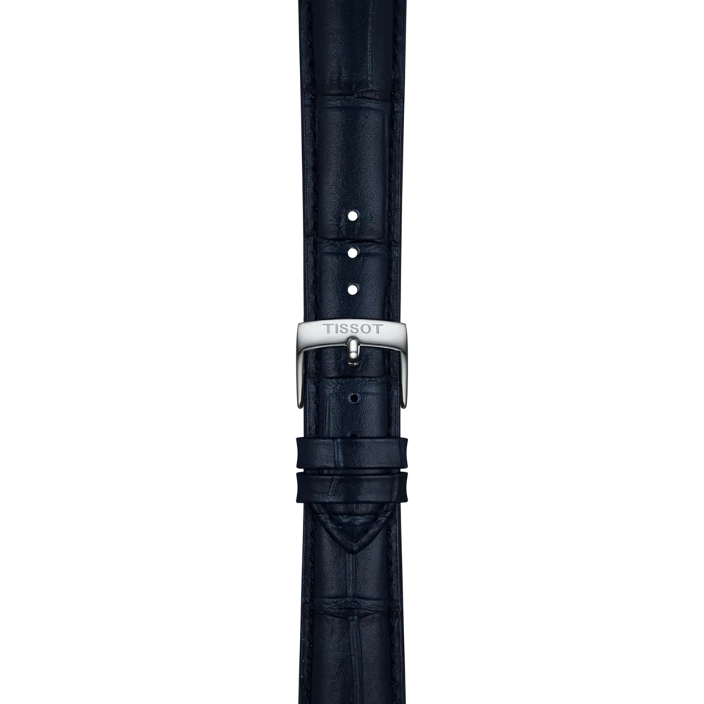 Blue leather watch strap by Tissot, featuring a crocodile pattern and several adjustment holes. The strap includes a silver buckle engraved with "TISSOT" and lugs measuring 18mm, displayed vertically against a plain light background.