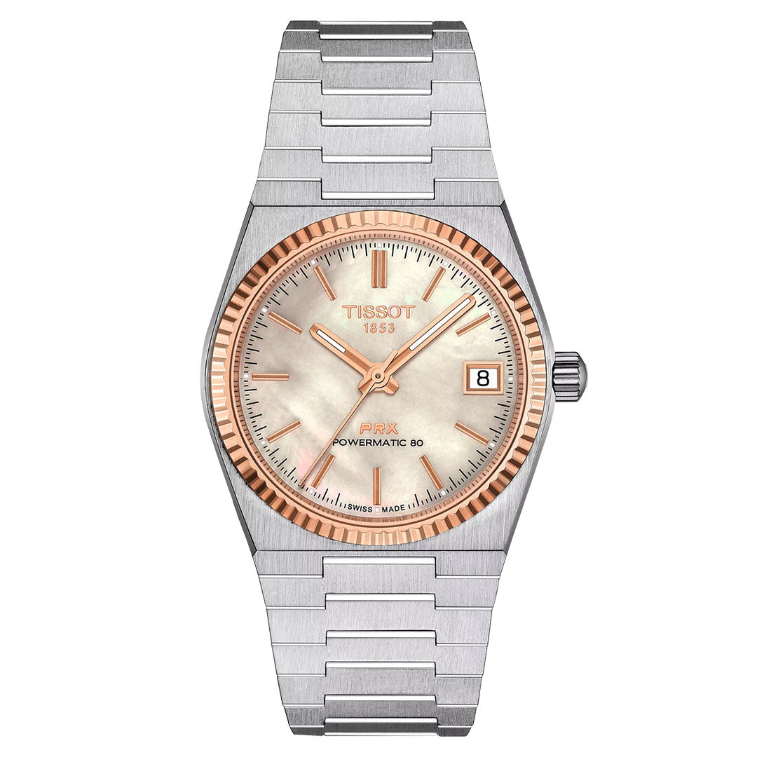 The Tissot PRX 18K Gold Powermatic 80 Automatic 35mm watch features a silver metal bracelet, light dial, gold hands and markers, an 18K gold bezel, and a date window at 3 o’clock.