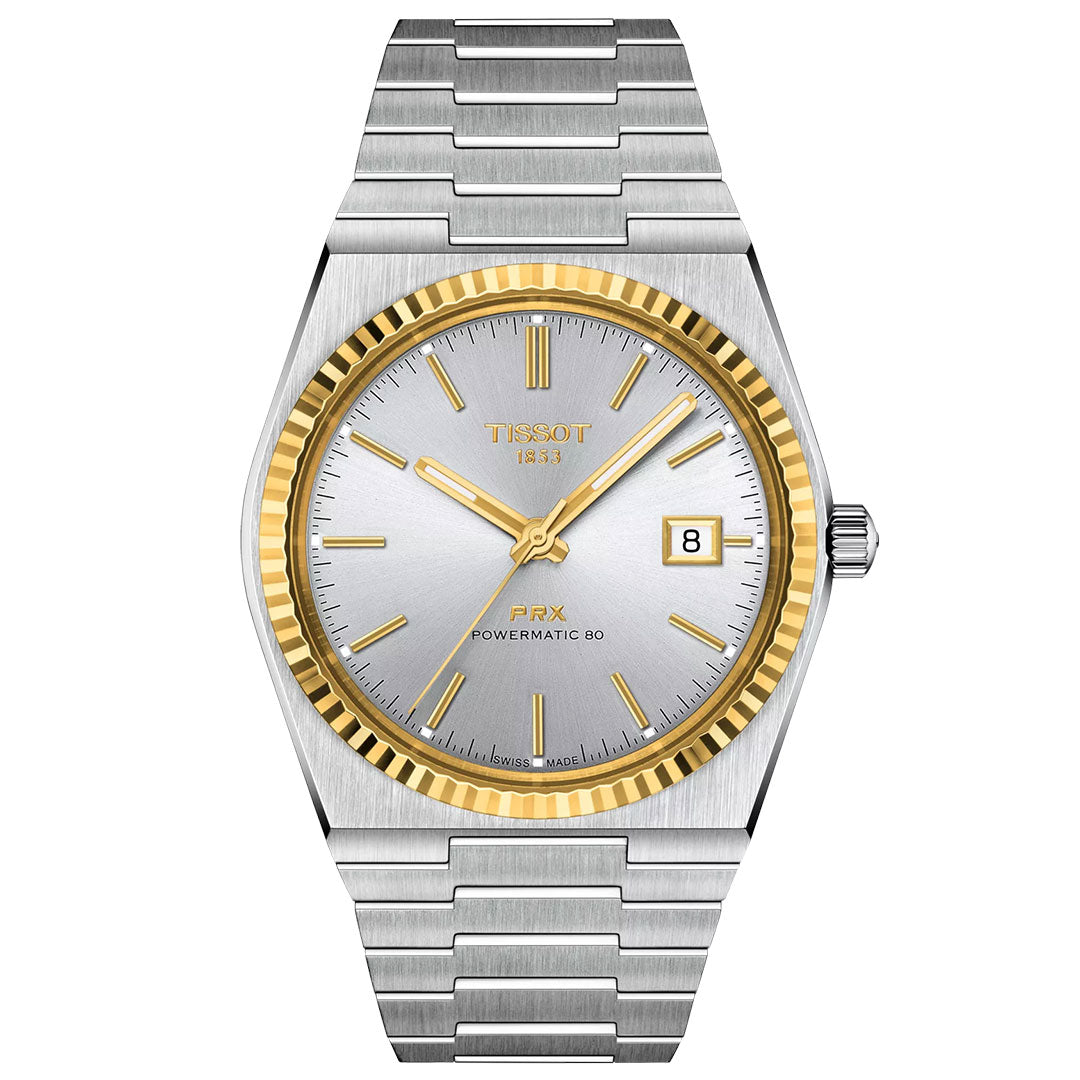 The Tissot PRX 18K Gold Powermatic 80 Automatic 40mm Watch features a silver and gold-tone stainless steel band, silver dial with gold markers and hands, date at 3 o'clock, fluted gold bezel, and scratch-resistant sapphire crystal.