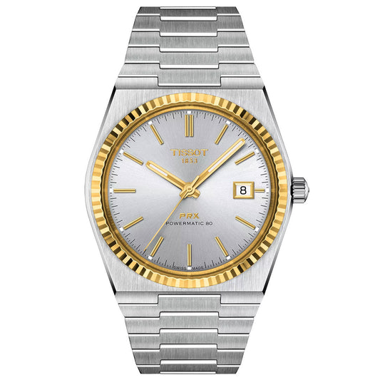 The Tissot PRX 18K Gold Powermatic 80 Automatic 40mm Watch features a silver and gold-tone stainless steel band, silver dial with gold markers and hands, date at 3 o'clock, fluted gold bezel, and scratch-resistant sapphire crystal.