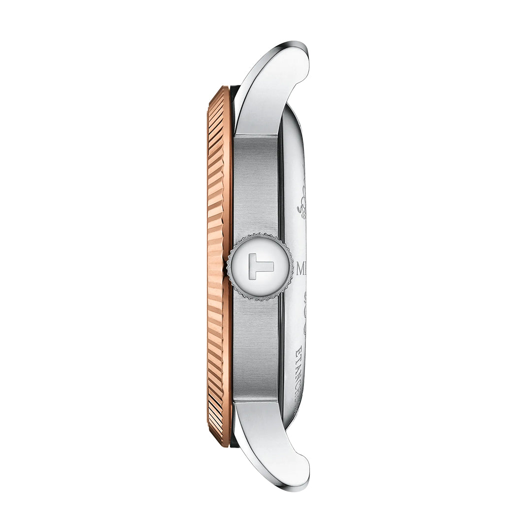 Side view of the Tissot Le Locle COSC Automatic 39.3mm Watch with an 18K gold ridged bezel, silver case, and "T" logo crown. The Swiss automatic model features visible lugs at the top and bottom.