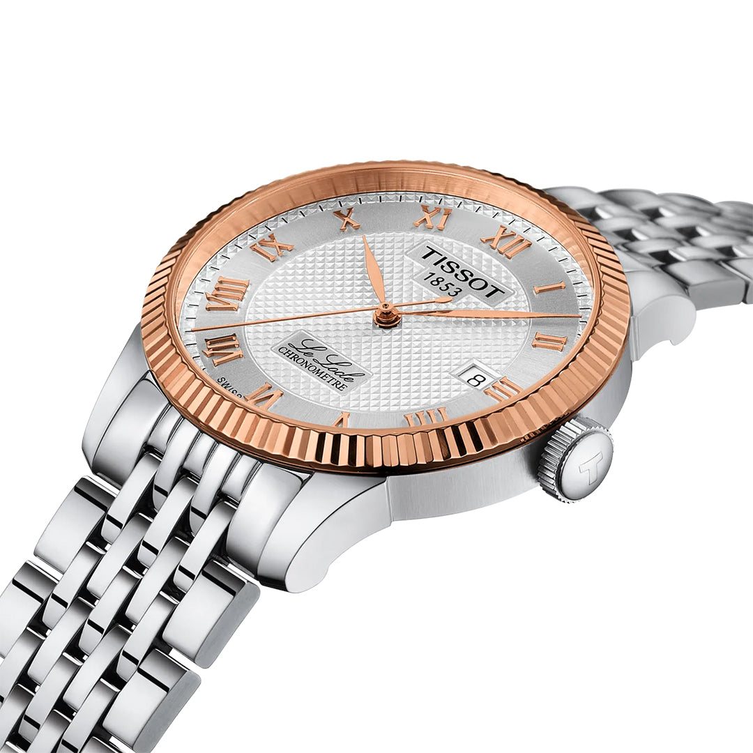The Tissot Le Locle COSC Automatic 39.3mm watch features a silver metal band, silver textured dial, rose gold Roman numeral indices, and an 18K gold bezel. Includes Swiss automatic movement, date display, and "Le Locle" on the dial.