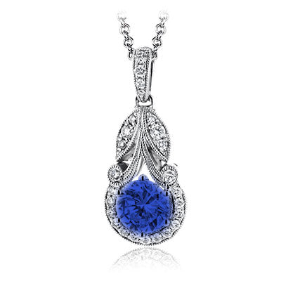 The Simon G. 18K White Gold Diamond with Sapphire Necklace Pendant showcases a vintage-inspired design with a large round sapphire, ornate detailing, and sparkling diamonds for a timeless look.