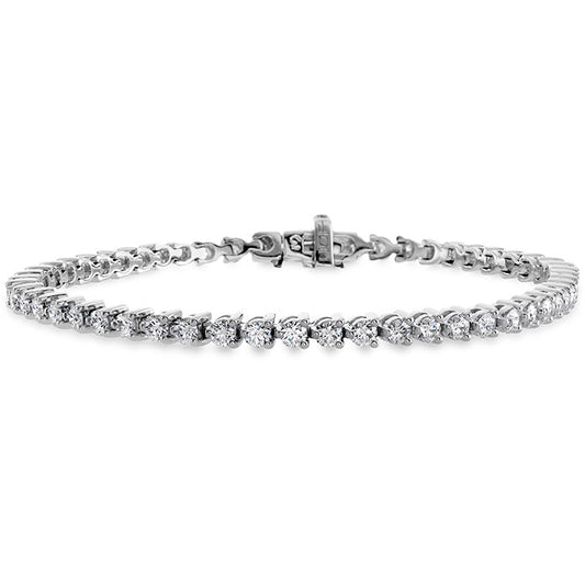 The Hearts On Fire Temptation Tennis Bracelet by Hearts on Fire showcases a series of round, sparkling diamonds elegantly set in white gold, forming a continuous and refined line. The bracelet is equipped with a secure clasp for added safety.