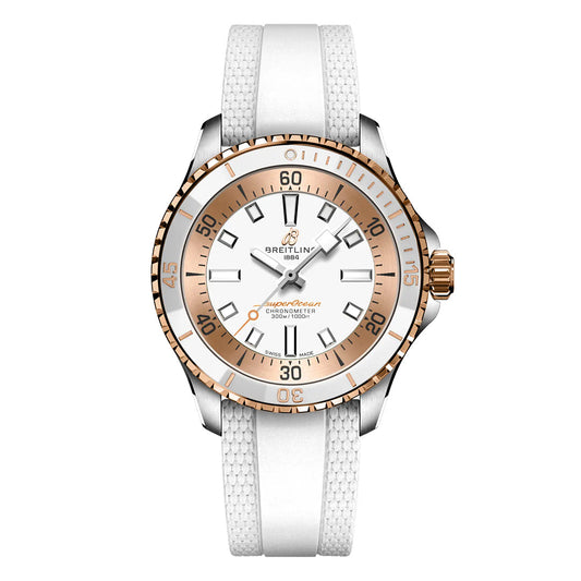 The BREITLING Superocean Automatic 36 features a white dial, rose gold bezel, white rubber strap, luminous hands and markers, plus a date display at 6 o’clock.