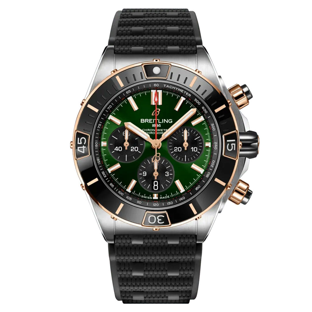 The BREITLING Chronomat B01 44 is a distinguished sports watch by Breitling, featuring a green and black dial with gold accents. It includes three subdials, a tachymeter scale, and is completed with a textured black strap and gold pushers for an exquisite finish.