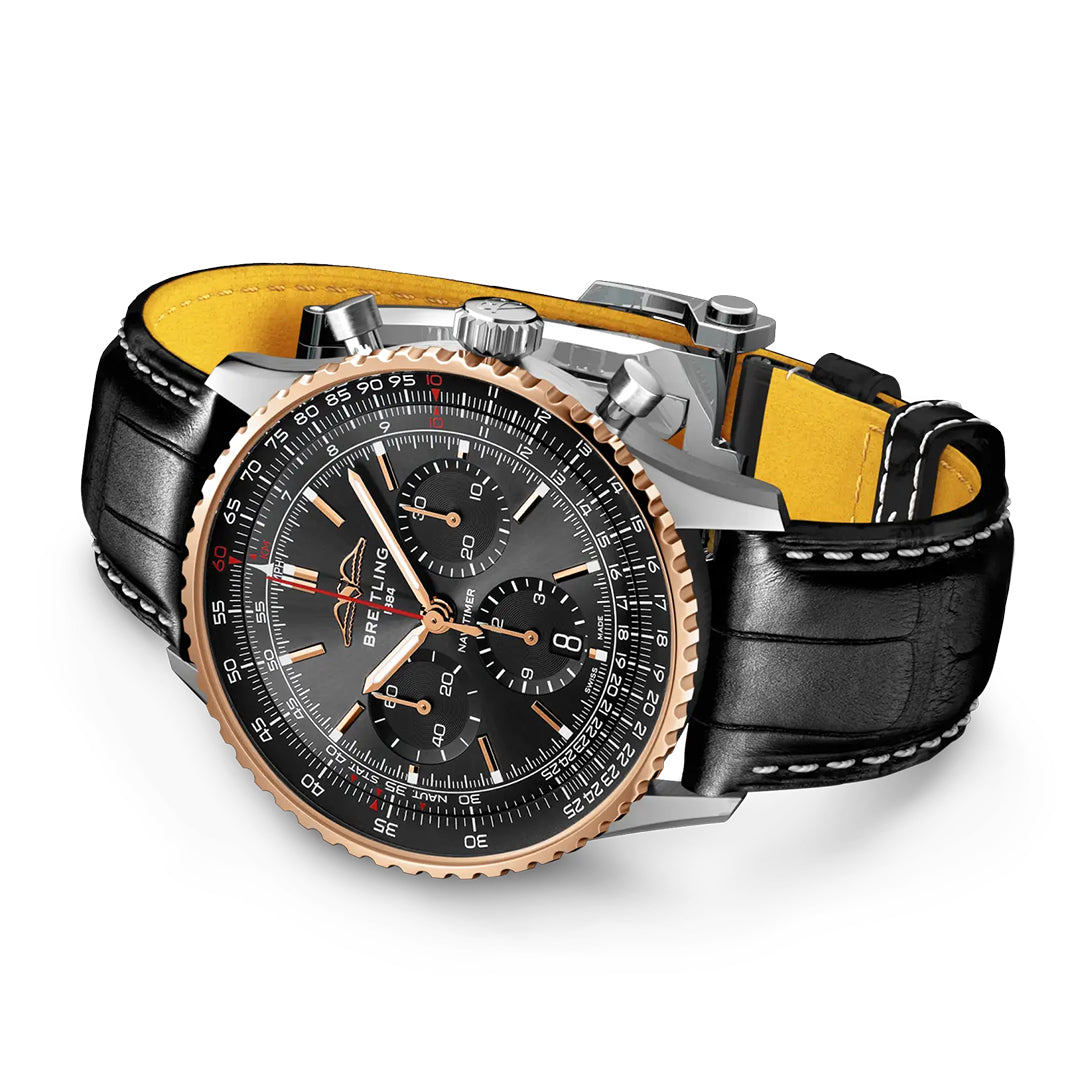 The Breitling Navitimer B01 Chronograph 43 Limited Edition features a black dial, rose gold bezel, black leather strap with yellow lining, three subdials, and silver pushers—an iconic pilot’s watch shown at an angle.