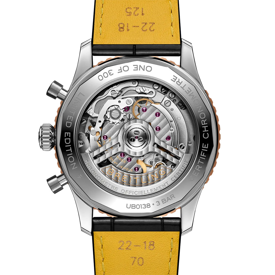 Close-up of the back of the Breitling Navitimer B01 Chronograph 43 Limited Edition, showing its transparent case with intricate mechanical gears and engraved details, and finished with a striking yellow leather strap.