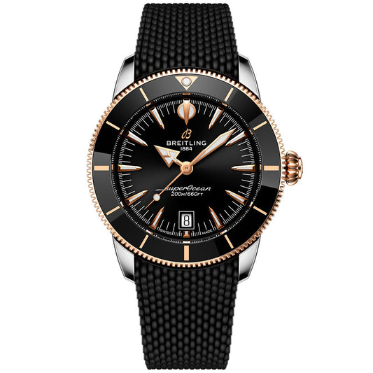 The BREITLING Superocean Heritage B31 Automatic 42 features a black dial with gold accents, black bezel, date display at 6 o’clock, textured black strap, and is water resistant to 200m/660ft.