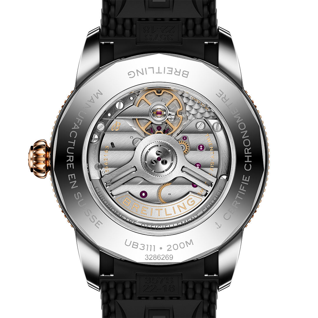Close-up of the back of a Breitling Superocean Heritage B31 Automatic 42, highlighting its detailed mechanical movement, engraved case back, visible gears through the transparent rear, and attached black strap.