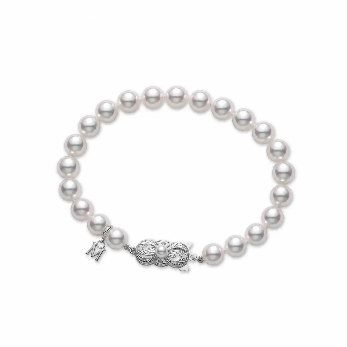 The Mikimoto Akoya Cultured Pearl Strand Bracelet features lustrous Akoya cultured pearls, a decorative 18K white gold clasp, and a small silver charm shaped like the letter “M.”.