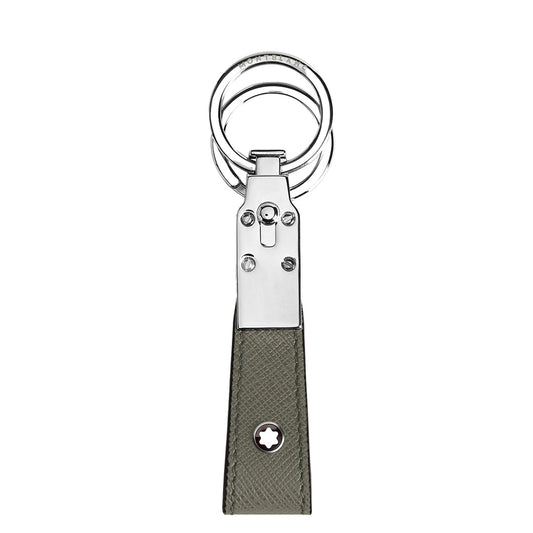 The Montblanc Sartorial Loop Key Fob features dual silver rings, a detachable ring, a rectangular gray Saffiano leather strap, and a small circular white star emblem near the bottom.
