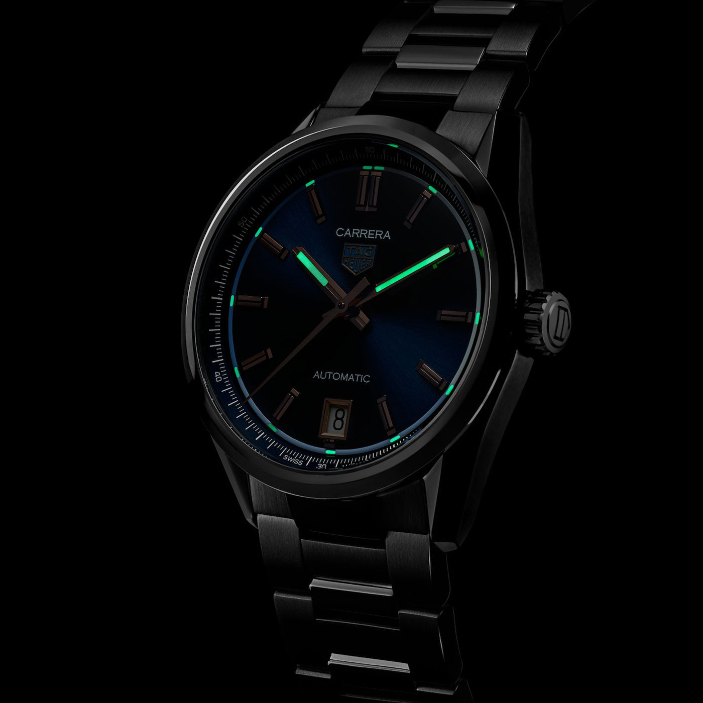The TAG Heuer Carrera Date Automatic 36mm Watch features a sleek black metal case and bracelet, a striking blue and black dial with luminous green hour markers and hands, a date window at 6 o’clock, and the iconic “CARRERA” and “AUTOMATIC” inscriptions. This elegant timepiece by TAG Heuer is powered by the precise Caliber 7 Automatic movement.