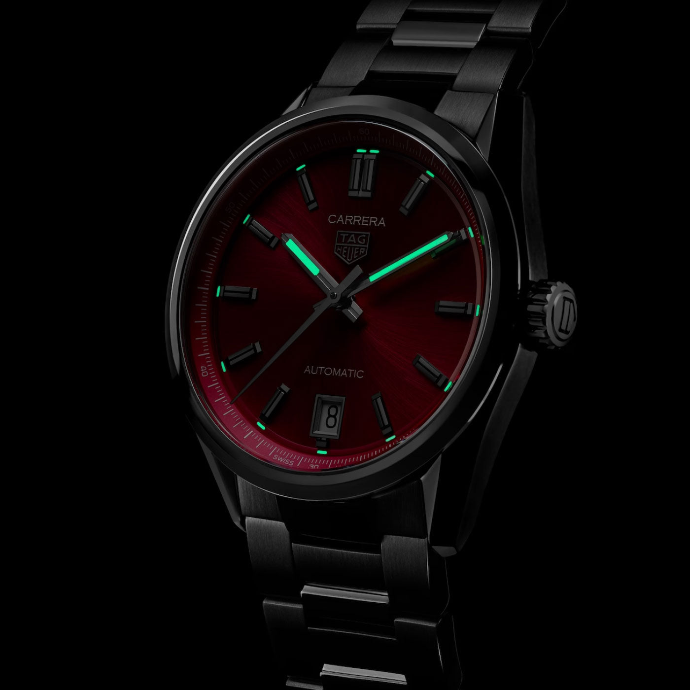 The TAG Heuer Carrera Date Automatic 36mm Watch by TAG Heuer features a deep red dial, luminous green hands and markers, a date window at 6 o’clock, and a black metal bracelet, displayed against a dark background.