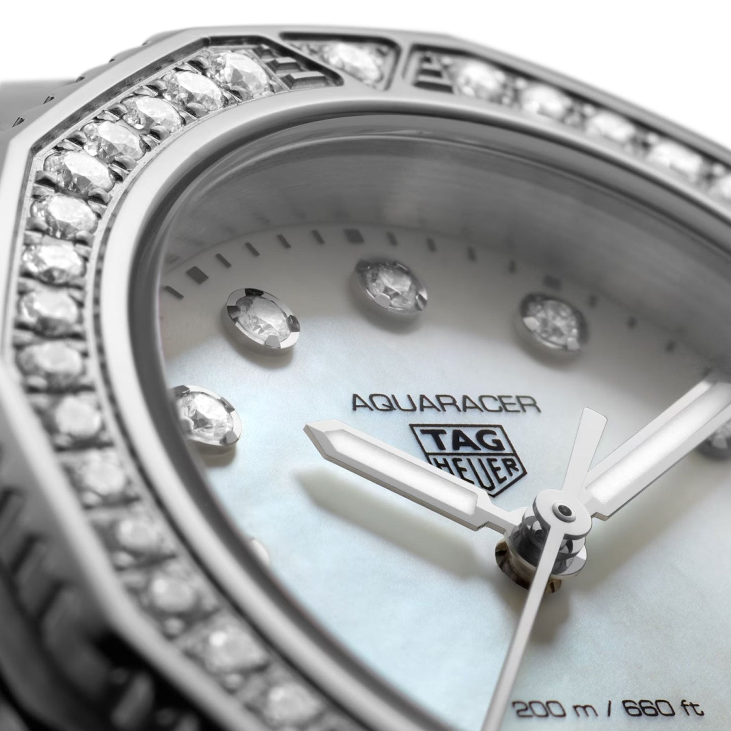 Close-up of the TAG Heuer Aquaracer Professional 200 Quartz 30mm watch face, showcasing diamond hour markers, a diamond-set bezel, silver-tone hands, and a mother-of-pearl dial adorned with the TAG Heuer logo and “200m/660ft” water resistance marking. The sophisticated 30mm stainless steel case houses a precise quartz movement for dependable performance.