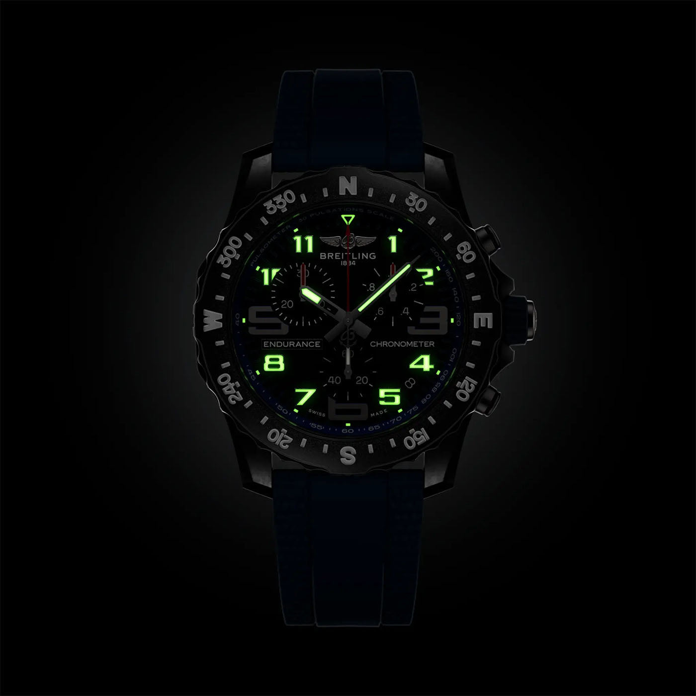 Introducing the BREITLING Endurance Pro 44: a sleek black wristwatch from Breitling that features luminous green numbers and hands for optimal visibility in low light. With its compass-marked bezel, subdials, and "Chronometer" label on the face, this athleisure timepiece combines style with functionality. It is complemented by a durable Breitlight® strap, ensuring robust performance for any adventure.