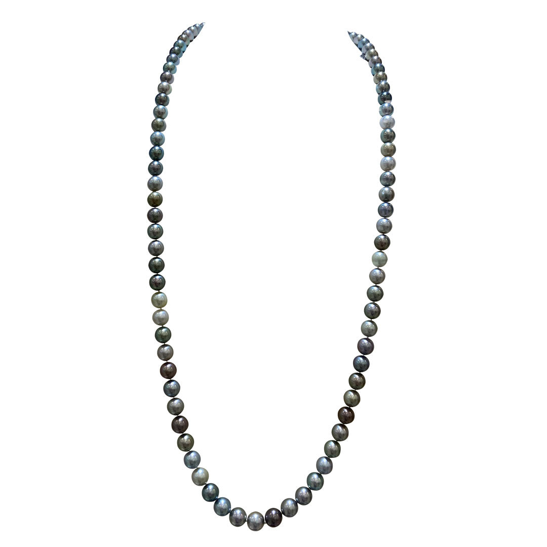 The Mikimoto 35" necklace showcases a continuous loop of uniformly sized South Sea black pearls exhibiting subtle iridescence. This elegant piece is accentuated by an 18-karat white gold clasp against a plain white background, combining simplicity with sophistication.