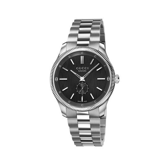 The Gucci G-Timeless Automatic 40mm Watch by GUCCI features a black dial adorned with silver hands, hour markers, and a date function. This stainless steel timepiece includes a fluted bezel and a sleek steel bracelet that enhances its sophisticated design.