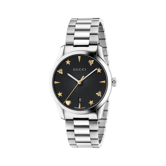 The Gucci G-Timeless Quartz 38mm Watch by GUCCI Watch boasts a black dial adorned with gold star and bee hour markers, as well as a date window positioned at 6 o'clock. Complemented by a sophisticated metal link band, this refined timepiece prominently displays the iconic Gucci name on its face.